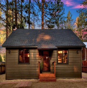 A small, single-story wooden cabin with a dark shingled roof, a front porch, and a visible number '3834' on the side. - High Sierra Hideaway - Cozy Modern Cabin (south lake tahoe)