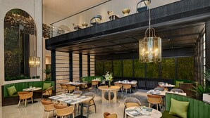 A modern indoor dining area with round tables, wicker chairs, and green upholstered seating. - Doubletree By Hilton Shenzhen Bay (Shenzhen)