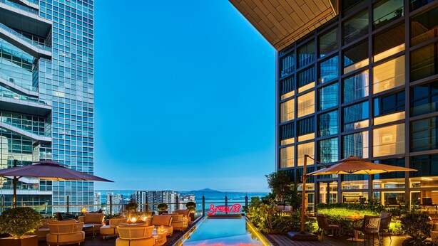 A rooftop pool area with lounge seating and a neon sign. - Doubletree By Hilton Shenzhen Bay (Shenzhen)