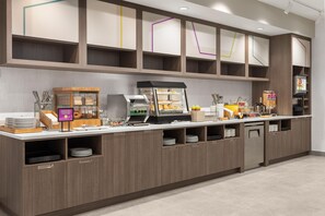 A self-service breakfast station with a coffee machine, a display case with pastries, and a beverage dispenser. - Home2 Suites By Hilton Vaughan Toronto On (Vaughan)