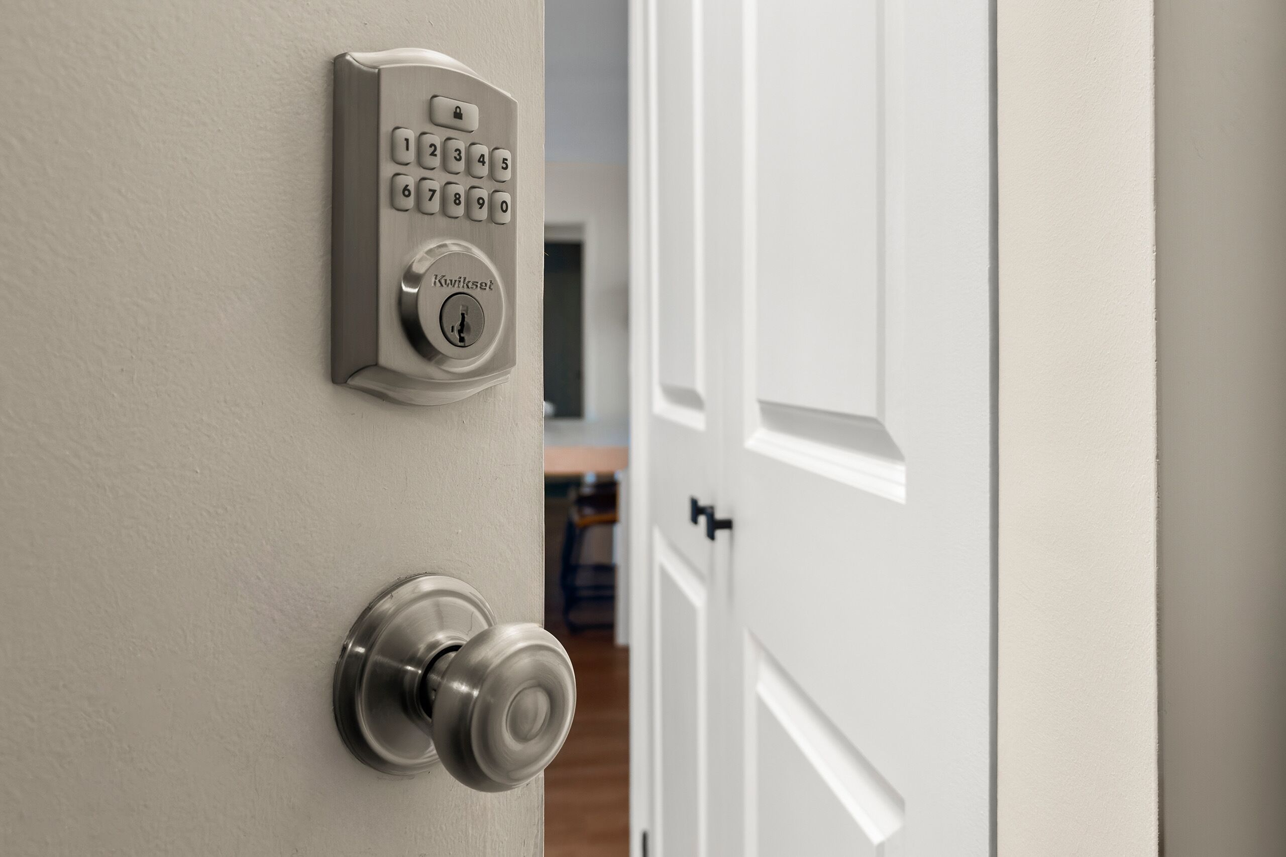 A door with a numeric keypad and a keyhole, indicating a secure entry point.