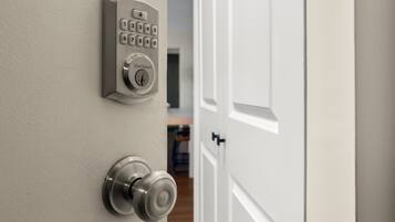 A door with a numeric keypad and a keyhole, indicating a secure entry point.