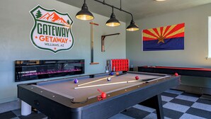A pool table with cue sticks, a pool table, and a sign for Gateway Getaway in Williams, AZ. - Gateway Getaway in wonderful Williams with fire pit, sauna, game room and views! (Williams)
