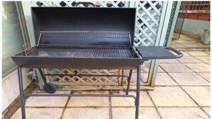 A portable grill with wheels, set on a tiled patio. - Fantastic Large Room with  free parking (Chatham)