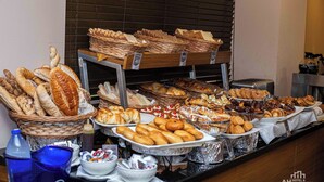 A buffet with various breads, pastries, and desserts. - Ah Hotel and Conferences (Accra)