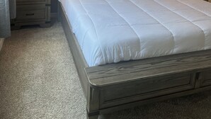 A neatly made bed with white linens, two bedside lamps, and a wooden headboard. - Charming 2-bedroom townhome with WiFi, AC in brilliant Davenport (Davenport)