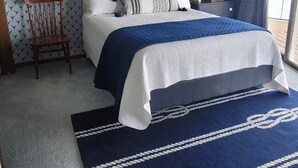 A bedroom with a bed, a chair, a rug, and a ceiling light. - Lake Gage Getaway,
Where every season feels like a vacation. (Angola)