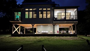 A two-story house with a covered patio and a garage.