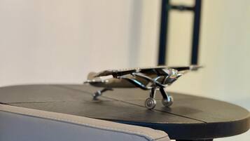 A small round table with a metal airplane model on top.