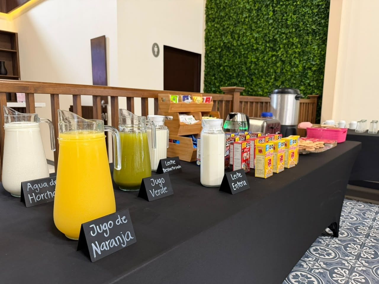 A breakfast buffet with various beverages and food items.