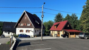 A building with a sloped roof, a satellite dish, and a sign that reads "HOTEL".