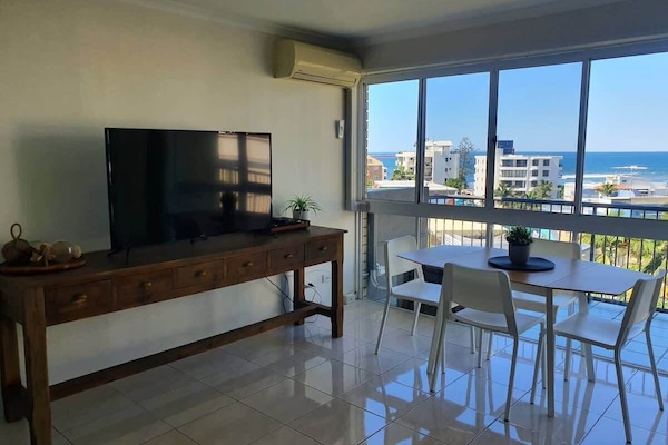 Unwind in the bright, breezy living space with comfy seating, a Smart TV, and incredible coastal views.