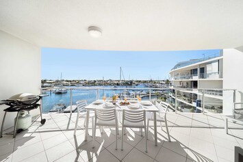 Dine alfresco, sip coffee, or watch boats drift by from the balcony overlooking the calm marina waters