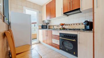 Fridge, microwave, coffee/tea maker, cookware/dishes/utensils