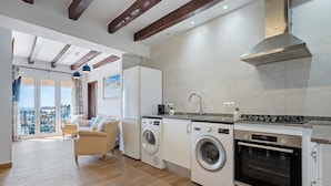 A modern kitchen with built-in appliances, a dining area with a view, and a laundry room.
