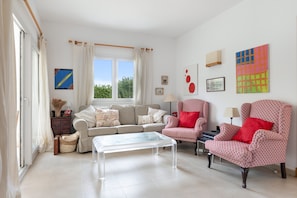 A living room with a sofa, armchairs, a coffee table, and artwork on the walls. - Holiday Home 'Tres' with Private Pool, Private Terrace and Wi-Fi (Es mercadal)