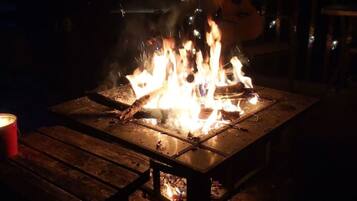 A campfire on a wooden table at night.