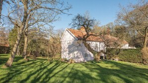 A white house with a red roof, surrounded by trees and a well-maintained lawn. - Mulberry End, Foxhall (Foxhall)