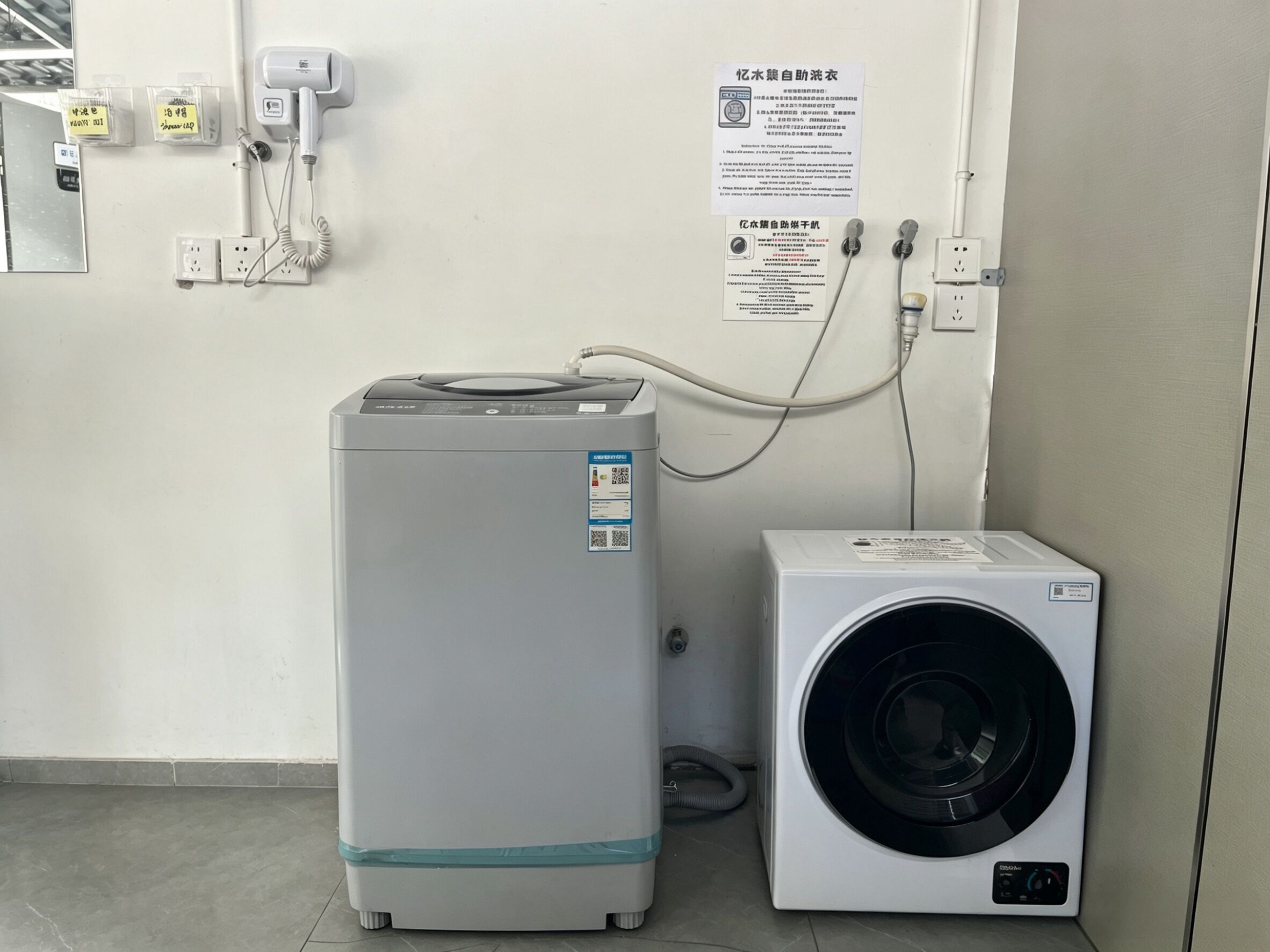 A compact, modern laundry room with a front-loading washing machine and a stacked dryer.