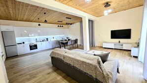 Un appartement moderne comprenant une cuisine, un coin repas et un salon.
