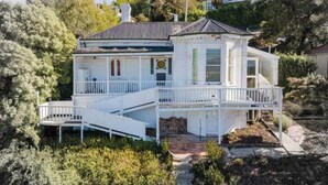 A two-story house with a balcony, a staircase, and a garden. - Forest Rd Haven with Tamar River Views (Trevallyn)