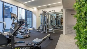 A gym with cardio machines, weightlifting equipment, and mirrors. - Prime Location 1BR vs Aricon&Pool beside Skytower (Auckland)