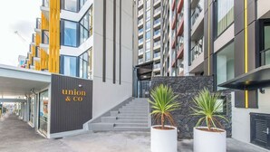 A modern building with a 'Union & Co' sign, a staircase, and two potted plants. - Incredible View Aircon 1B Studio Auckland Central (Auckland)