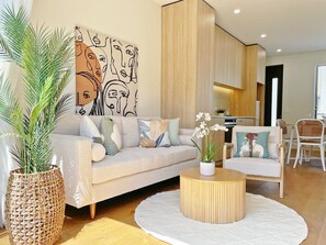 A modern living room with a sofa, coffee table, and decorative items.