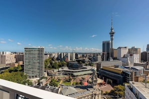 A cityscape with a prominent tower, various buildings, and a mix of modern and historical architecture.