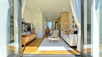 A modern living room with a sofa, coffee table, and decorative items.