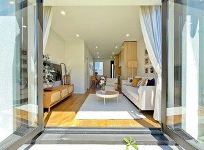 A modern living room with a sofa, coffee table, and decorative items.