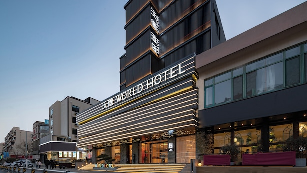 A modern hotel with a prominent sign reading "WORLD HOTEL". - WorldHotel Quancheng Sqr Kuanholi Branch (Jinan)
