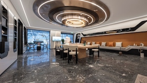 A modern hotel lobby with a central island, seating area, and a large window offering a city view. - WorldHotel Quancheng Sqr Kuanholi Branch (Jinan)