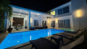 A modern house with a swimming pool, outdoor seating, and a patio area. - Luxurious & Charming 3BR VILLA Palmas Del Mar Pool/Jacuzzi/BBQ in lovely Sosúa (Sosúa)