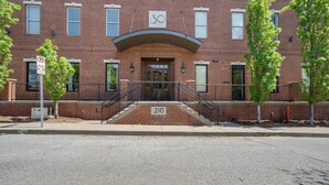 A brick building with a sign indicating it is a public facility. - Urban King Loft - Cali King - 8 Min to Broadway! (Nashville)