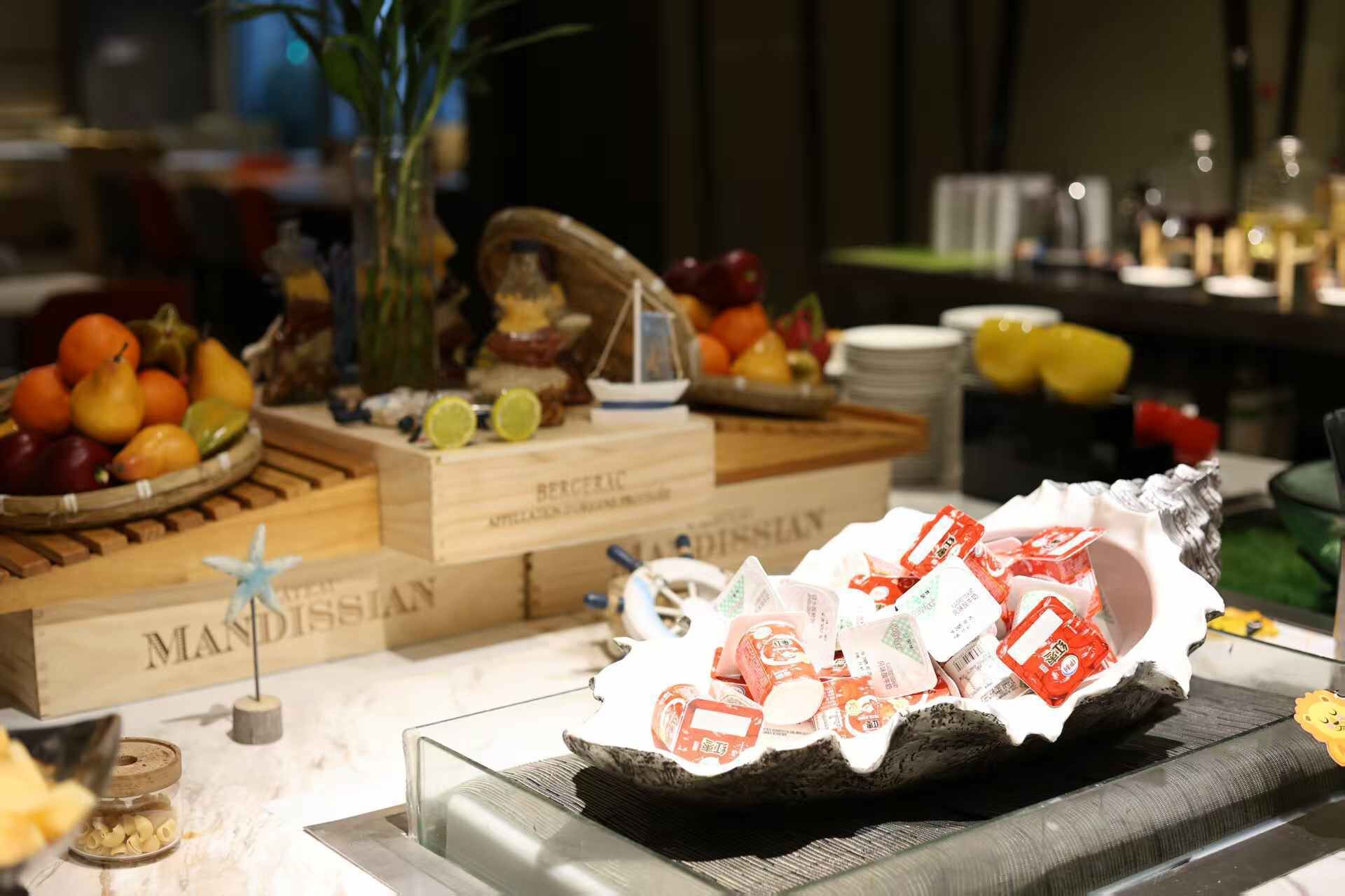 A buffet setup with various food items and a decorative centerpiece.