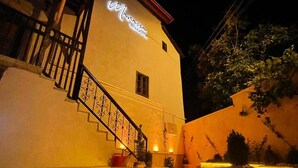 A building with a sign reading "Manasa Konak Hotel" at night. - Marassa Konak Otel (Ermenek)