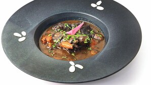 A dish with meat and vegetables in a bowl.