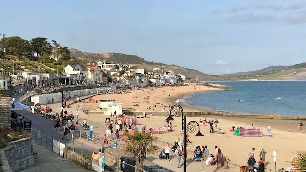 A coastal town with a beach, promenade, and buildings along the shore. - Meads Cabin - Charmouth, Lyme Regis (Charmouth)