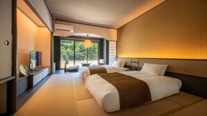 A modern hotel room with a large bed, a flat-screen TV, and a view of the outdoors. - Yamanaka Onsen KAJIKASO (Kaga)