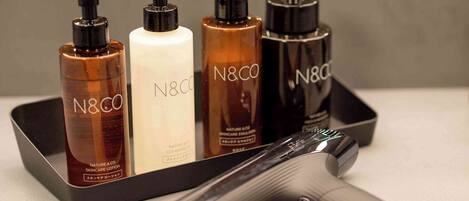 A set of N&CO skincare products on a tray with a hairdryer.