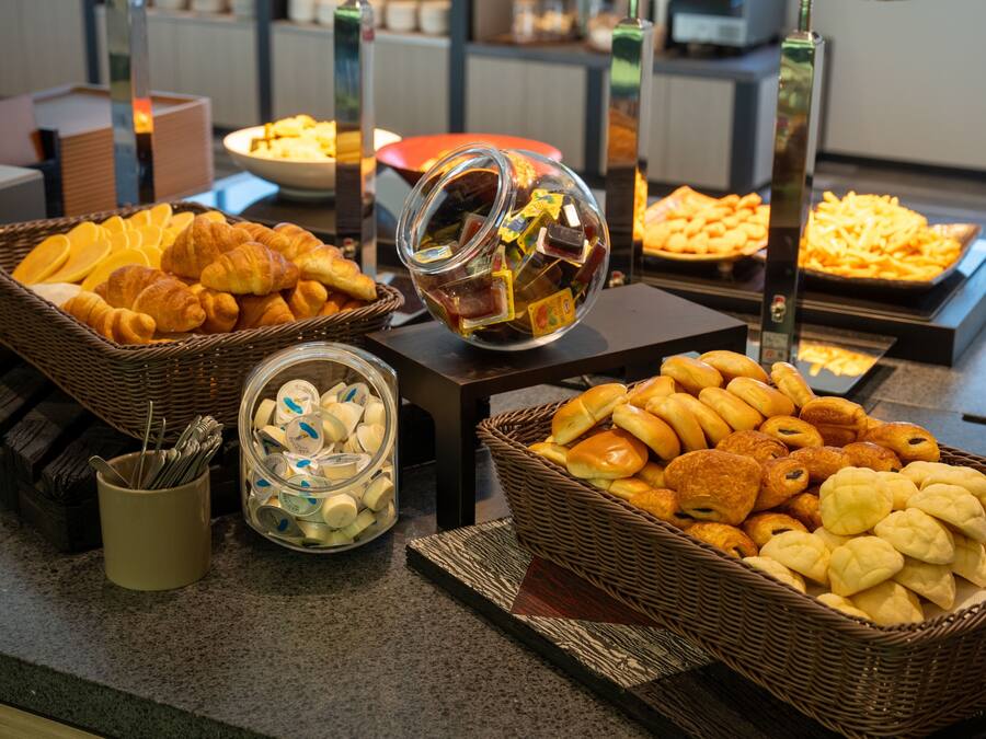 A buffet with various baked goods and pastries.