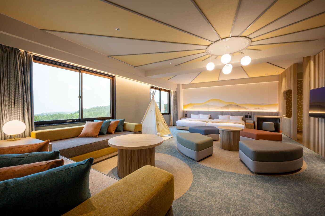 A modern hotel room with a large bed, seating area, and a view of the outdoors.
