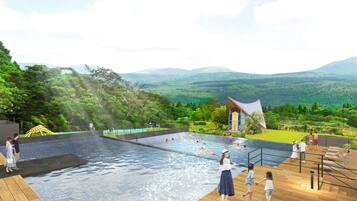 Relax by the pool surrounded by lush greenery and distant mountains.