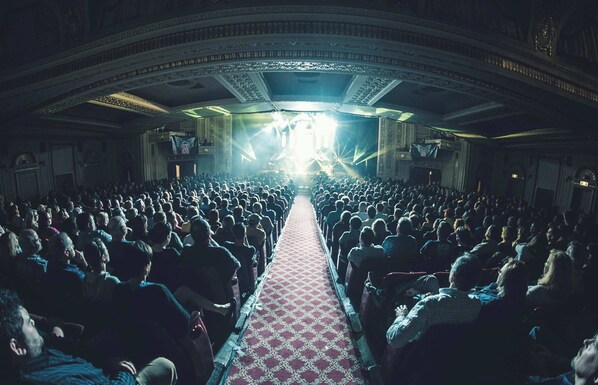 A large, ornate auditorium with a central aisle and rows of seats.