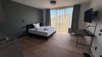 Studio | Desk, laptop workspace, blackout drapes, iron/ironing board