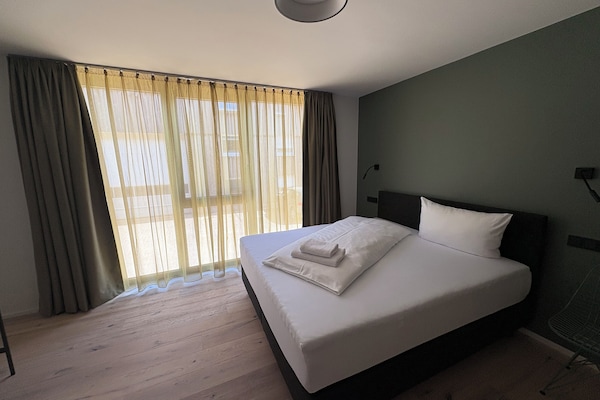 Studio | Desk, laptop workspace, blackout curtains, iron/ironing board