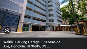 A multi-story parking garage with a sign for Ross on the 3rd floor. - Adorable 1-bedroom condo with kitchen, pool, WiFi near Waikiki Beach, sleeps 6-8 (Honolulu)