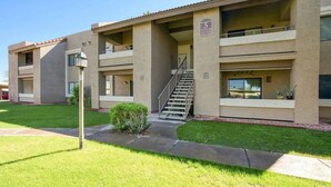 A multi-story building with a flat roof, a central staircase, and a small front garden. - Cozy 1-bedroom condo resort in charming Mesa with WiFi, AC (Mesa)