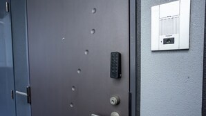 A metallic door with a keyhole, a keypad, and a handle. - HIT Tenjin (Fukuoka)